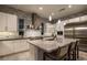 Bright kitchen features white cabinets, a large island with seating, and stainless steel appliances at 18 Garden Rain Dr, Las Vegas, NV 89135