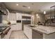 Spacious kitchen featuring a granite island, stainless steel appliances, and ample cabinet space at 18 Garden Rain Dr, Las Vegas, NV 89135
