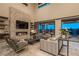 Modern living room with fireplace, stone accent wall, and floor to ceiling windows for seamless indoor/outdoor living at 18 Garden Rain Dr, Las Vegas, NV 89135