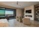 Bright living room features a fireplace, modern shelving, and access to a balcony with city views at 18 Garden Rain Dr, Las Vegas, NV 89135