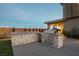 Outdoor kitchen featuring stainless steel grill, built-in storage, and stone accents for luxury backyard cooking at 18 Garden Rain Dr, Las Vegas, NV 89135