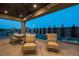 The patio features comfortable outdoor furniture, a built-in spa, and a beautiful view of the twilight sky at 18 Garden Rain Dr, Las Vegas, NV 89135