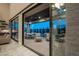 Seamless indoor-outdoor living with sliding glass doors to patio and outdoor dining at 18 Garden Rain Dr, Las Vegas, NV 89135
