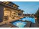Luxurious backyard boasts a sparkling pool, spa, and covered patio, perfect for outdoor gatherings and leisure at 18 Garden Rain Dr, Las Vegas, NV 89135