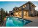 Stunning backyard features a refreshing pool and inviting patio area, ideal for outdoor relaxation and entertainment at 18 Garden Rain Dr, Las Vegas, NV 89135