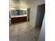 Bright bathroom with dual sinks, vanity with ample storage, and tile floors at 1837 Ardilea St, Las Vegas, NV 89135