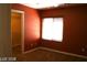 Bedroom with a window, tan carpet, and walk-in closet access at 1837 Ardilea St, Las Vegas, NV 89135