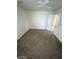 Bedroom featuring a ceiling fan, carpet flooring, and open door at 1837 Ardilea St, Las Vegas, NV 89135