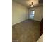 A carpeted bonus room featuring a light fixture, a window, and built-in shelving at 1837 Ardilea St, Las Vegas, NV 89135