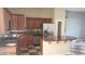 Kitchen featuring brown cabinets, stainless steel appliances and tile flooring at 1837 Ardilea St, Las Vegas, NV 89135