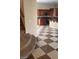 View of the kitchen from the stairwell featuring wood cabinetry, appliances, and granite countertops at 1837 Ardilea St, Las Vegas, NV 89135