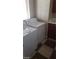 Bright laundry room featuring a washer, dryer, checkered floor and window with natural light at 1837 Ardilea St, Las Vegas, NV 89135
