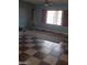 A view of the living room with large windows, natural light and tiled flooring at 1837 Ardilea St, Las Vegas, NV 89135