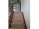 Carpeted stairs featuring a dark wood banister and decorative iron supports at 1837 Ardilea St, Las Vegas, NV 89135