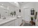 Bright bathroom featuring a dual sink vanity, mirror, tiled floors, and recessed lighting at 207 Callen Falls Ave # 1713, Henderson, NV 89011