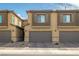 Exterior view of stylish townhomes with private garages and well-maintained landscaping at 207 Callen Falls Ave # 1713, Henderson, NV 89011