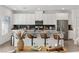 Modern kitchen features white cabinets, stainless steel appliances, and a stylish breakfast bar with seating at 207 Callen Falls Ave # 1713, Henderson, NV 89011