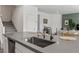 Modern kitchen island featuring a stainless steel sink and matte black faucet at 207 Callen Falls Ave # 1713, Henderson, NV 89011