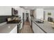 Modern kitchen featuring stainless steel appliances, gray countertops, and stylish black backsplash at 207 Callen Falls Ave # 1713, Henderson, NV 89011