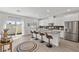Modern kitchen with a large island, stainless steel appliances, counter seating, and access to an outdoor area at 207 Callen Falls Ave # 1713, Henderson, NV 89011