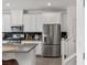 Modern kitchen with stainless steel refrigerator, white cabinets and gray countertops at 207 Callen Falls Ave # 1713, Henderson, NV 89011