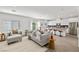 Open-concept living area with modern furnishings, flowing seamlessly into a stylish kitchen at 207 Callen Falls Ave # 1713, Henderson, NV 89011