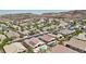 A beautiful desert community with homes, pools, and lush green landscaping and desert mountain backdrop at 2197 Big Bar Dr, Henderson, NV 89052