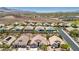 A picturesque aerial view of a desert community with homes, pools, and mountain backdrop at 2197 Big Bar Dr, Henderson, NV 89052