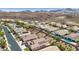 Aerial of a desert community featuring homes with swimming pools, desert landscape and desert mountain views at 2197 Big Bar Dr, Henderson, NV 89052