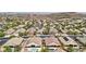 Expansive aerial view of a desert community featuring homes with pools and desert landscaping at 2197 Big Bar Dr, Henderson, NV 89052
