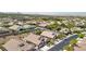 Wide aerial view showcasing a neighborhood with multiple homes, landscaping, and street at 2197 Big Bar Dr, Henderson, NV 89052