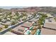 Expansive aerial view of a desert community featuring homes with pools, desert landscaping, and palm trees at 2197 Big Bar Dr, Henderson, NV 89052