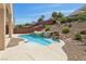 Lush backyard featuring a sparkling pool with water features and landscaping, creating a tranquil outdoor escape at 2197 Big Bar Dr, Henderson, NV 89052