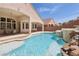 Charming backyard featuring a pool with water features, enhancing the outdoor living experience for relaxation and fun at 2197 Big Bar Dr, Henderson, NV 89052