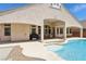 Expansive backyard featuring a pool with water features and a covered patio, creating a perfect outdoor entertainment space at 2197 Big Bar Dr, Henderson, NV 89052