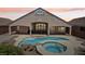Inviting backyard with a sparkling pool and spa, perfect for outdoor relaxation and entertainment under a colorful evening sky at 2197 Big Bar Dr, Henderson, NV 89052