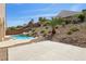Serene backyard featuring a sparkling pool with water features and a spacious patio area, perfect for relaxation at 2197 Big Bar Dr, Henderson, NV 89052