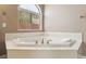 Bright bathroom with corner bathtub and natural light from the window at 2197 Big Bar Dr, Henderson, NV 89052