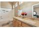 Bright bathroom featuring double sinks, a large mirror, and a shower-tub combo at 2197 Big Bar Dr, Henderson, NV 89052