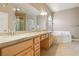 Bright bathroom featuring dual sinks, white countertops, bathtub and tile flooring at 2197 Big Bar Dr, Henderson, NV 89052