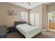 Bedroom with neutral carpet, ceiling fan, window with blinds, with bed, dresser, and closet at 2197 Big Bar Dr, Henderson, NV 89052