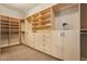 Walk-in closet offers custom shelving, drawers, and clothing racks at 2197 Big Bar Dr, Henderson, NV 89052