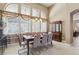 Bright dining area with large windows, modern furnishings, and a stylish china cabinet at 2197 Big Bar Dr, Henderson, NV 89052