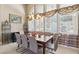 Elegant dining room with a large window, stylish chandelier, and seating for eight at 2197 Big Bar Dr, Henderson, NV 89052