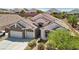 Charming home boasts a three-car garage, well-maintained landscaping, and a stone facade at 2197 Big Bar Dr, Henderson, NV 89052