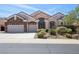 Charming single-story home featuring a three-car garage and manicured landscaping at 2197 Big Bar Dr, Henderson, NV 89052