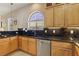 Bright kitchen features wooden cabinets, black countertops, backsplash, and stainless steel appliances at 2197 Big Bar Dr, Henderson, NV 89052