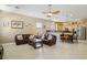 Open living room adjacent to the kitchen with stainless steel appliances and breakfast bar at 2197 Big Bar Dr, Henderson, NV 89052