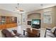 Comfortable living room with fireplace, shelving, and natural light at 2197 Big Bar Dr, Henderson, NV 89052