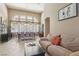 Comfortable living room featuring tile floors and large windows with backyard views at 2197 Big Bar Dr, Henderson, NV 89052